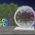 Outdoor Night Scene With Circular Love One Another Installation And Love You Sign