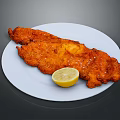 Crispy Golden Fried Chicken Breast Served With Lemon Wedge On White Plate