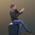 Man Sitting On Black Stool Using Smartphone In Dark Long Sleeve Top And Blue Jeans