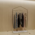 Various Stylish Clothes Hanging on Transparent Rack Against Beige Wall Background