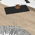 Modern Minimalist Side Table With Black Tabletop And Metal Legs Featuring Coffee Cup On Top