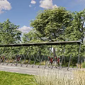 Waterfront Landscape With Bicycle Shelter And Parked Bicycles Near Trees And Grass