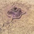 Intricate Sandcastle Structure On Sandy Ground With Detailed Design And Small Openings