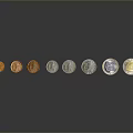 Carved Coin Sculptures In Different Colors Arranged In A Row With Metallic Finish