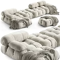 Light Beige Irregular Shaped Sofa With Plush Velvet Tufted Design And Knitted Blanket