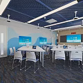 Modern Classroom Interior With Blue Ceiling White Tables Chairs And Screens