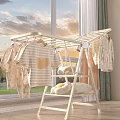 Indoor Clothes Drying Rack With Baby Clothes Striped T-shirt And Plush Toys In Natural Light