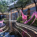 Modern Garden Landscape with Pink Giraffe and Deer Sculptures Water Pool Green Plants Illuminated Path