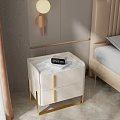 Modern Cream Colored Bedside Table With Drawers Gold Handles And Alarm Clock In Bedroom