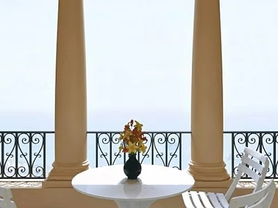 White Round Table And Chairs On Balcony With Sea View And Wrought Iron Railing 3d model