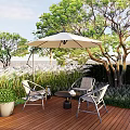 Outdoor Table and Chair Set With White Umbrella On Wooden Deck Surrounded by Green Trees