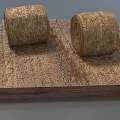Two Round Hay Bales Placed On Square Wooden Base With Dry Straw