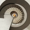 Modern Interior Spiral Staircase With Lighted Marble Steps And Golden Center Sculpture