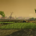 Beautiful Rural Landscape with Green Fields Distant Village and Farmers Working Under Amber Sky