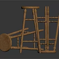 Natural Wooden Stools With Round Seats And Slender Legs In Standing And Fallen Positions