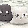 Cute Gray And White Ghost Shaped Soft Pillows With Adorable Facial Expressions On Marble Surface
