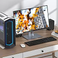 Modern Desktop Computer Setup with Monitor Case Keyboard Mouse and Speakers on Wooden Desk