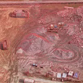 Aerial Planning View Of Construction Site With Sand Piles Trucks And Materials
