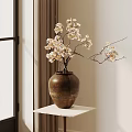 Brown Ceramic Vase with White Blossoms on White Shelf in Interior with Curtain and Window