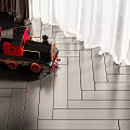 Electric Toy Train Red and Black Classic Design on Wooden Floor with White Curtains