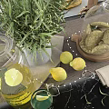 Elegant Kitchen Utensils Featuring Glass Jars Lemons Cookies Recipe Book And Wooden Cutting Board