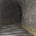 Stone Stairs In Tunnel Like Structure With Stone Walls And Yellow Railings