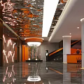 Modern Luxury Lobby Front Desk Reception with Orange Columns Mirrored Ceiling and Marble Floor Lighting