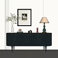 Dark Entryway Console Table with Vase Plants Framed Art and Table Lamp against Light Wall