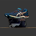 Blue Running Shoes With Multi Colored Laces And Supportive Sole On Brand Box