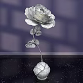 Floral Art Display Featuring Purple Paper Flower With Silver Stem And Gray Spherical Vase