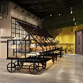 Bright Dessert Shop Interior Featuring Glass Display Cases Pastries Green Plants And Decorative Bicycle