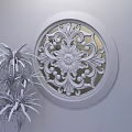 Elegant Circular Carved Window Decoration With Intricate Wooden Patterns And Green Plant