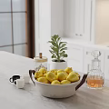 Bright Kitchen Counter With Lemon Bowl Potted Plant Glass Jars And White Cabinets