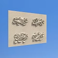 Intricate Metallic Carvings With Floral And Curved Motifs On Light Colored Wall