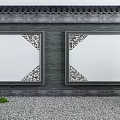 Traditional Chinese Gray Building Exterior Wall Featuring Ornate Carved White Panels Gravel And Grass