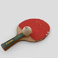 Worn Red Table Tennis Racket With Green Handle Yellow Label And White Ping Pong Ball