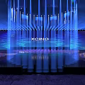 XCIND Modern Stage with Blue Lighting Illuminated Pillars and Audience Seats