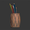 Copper Pen Holder With Colored Pencils On Dark Reflective Surface