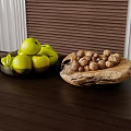 Fresh Green Apples in Black Plate and Walnuts in Wooden Tray on Dark Wooden Table