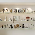 Modern Decorative Ornaments Set On Display Shelves With Sculptures Vases Photo Frames And Books