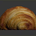 Golden Flaky Croissant On Dark Surface With Shiny Reflection