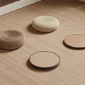 Four Different Styles Round Woven Floor Cushions Placed On Wooden Floor
