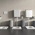 Three Modern Toilets White Cisterns Gray Bins Toilet Paper Holders Light Gray Wall Dark Floor