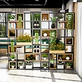 Modern Wooden Multi Compartment Shelving Unit In Bright Interior With Plants Books And Bottles