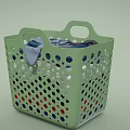 Green Perforated Laundry Basket Holding Colorful Clothes For Everyday Use