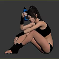 Woman in black sportswear sitting on floor holding blue water bottle with wrist knee supports