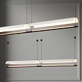 Modern Linear Chandeliers With Soft Glow Illumination Hanging In Contemporary Room