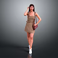 Woman In Plaid Dress With Brown Purse And White Sneakers Standing Against Gray Background
