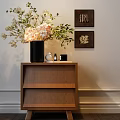 Elegant Wooden Nightstand With Black Vase Pink White Flowers Green Leaves And Framed Wall Art