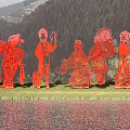 Garden Landscape with Red Paper Cut Figures in Traditional Costumes and Green Mountains by Water